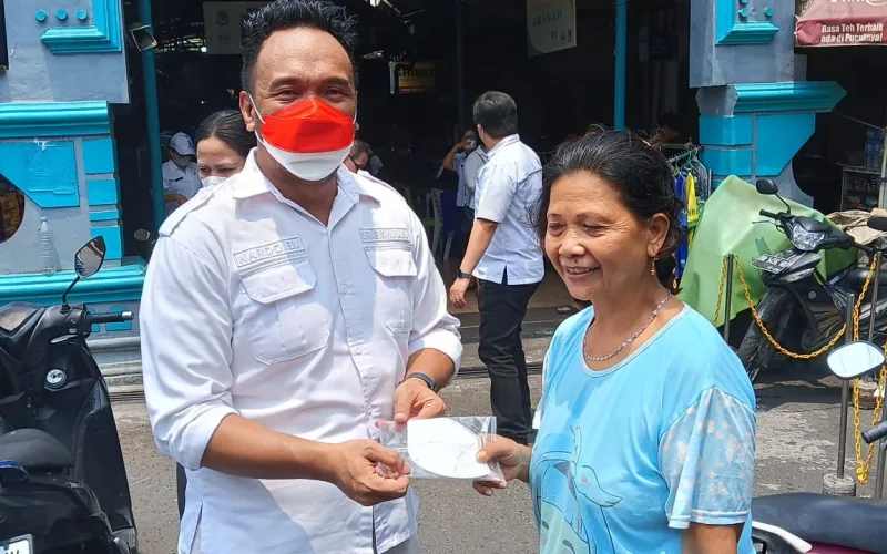 Stafsus Januardo Binilang saat membagikan masker kepada warga